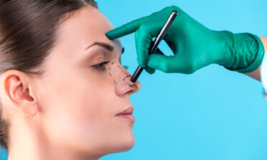 Cosmetic Surgeon Examining Female Client