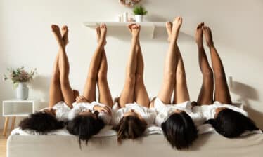 women laying with legs in the air